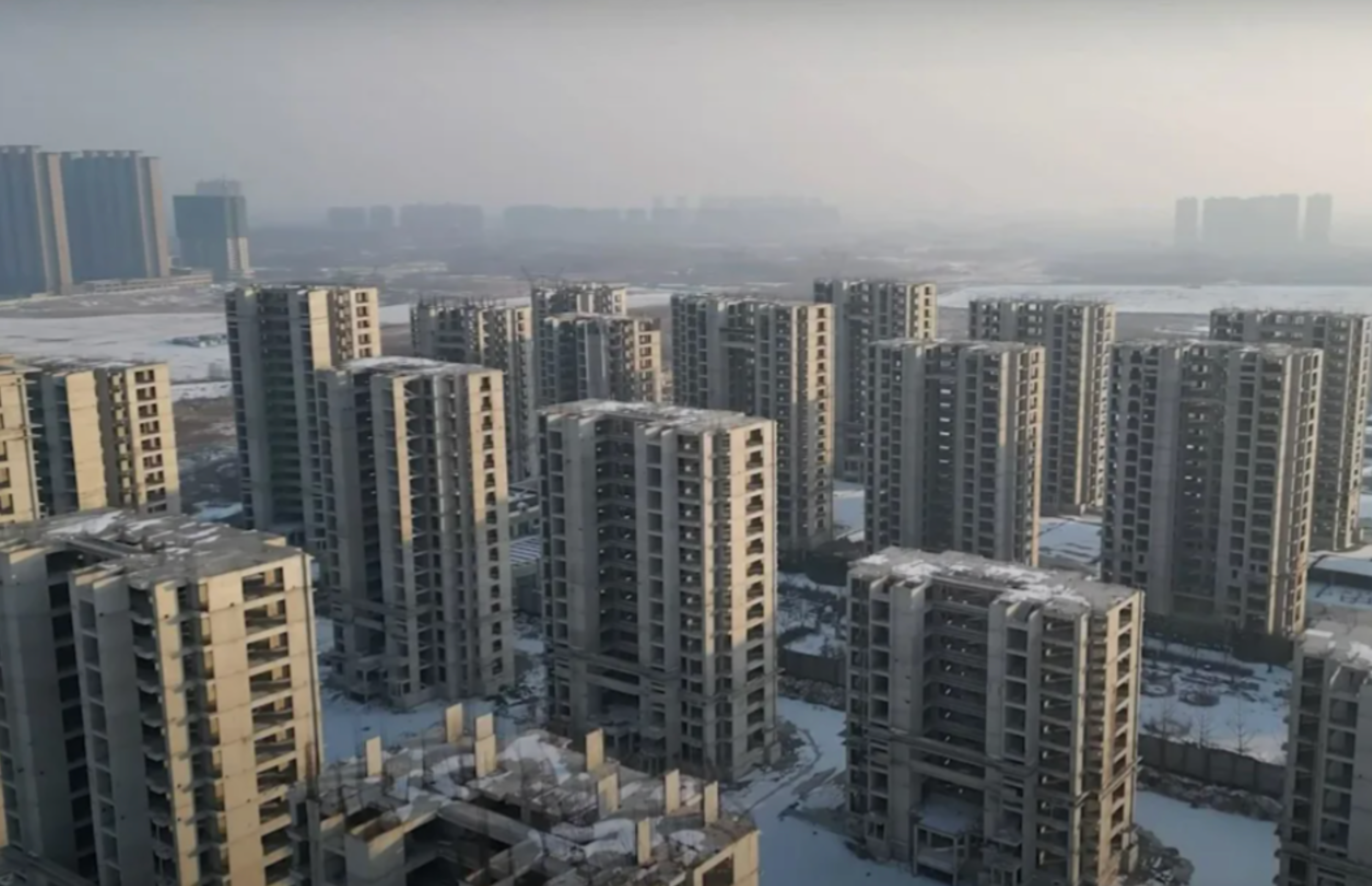 Large unfinished residential towers in China, symbolizing the country’s prolonged housing crisis.