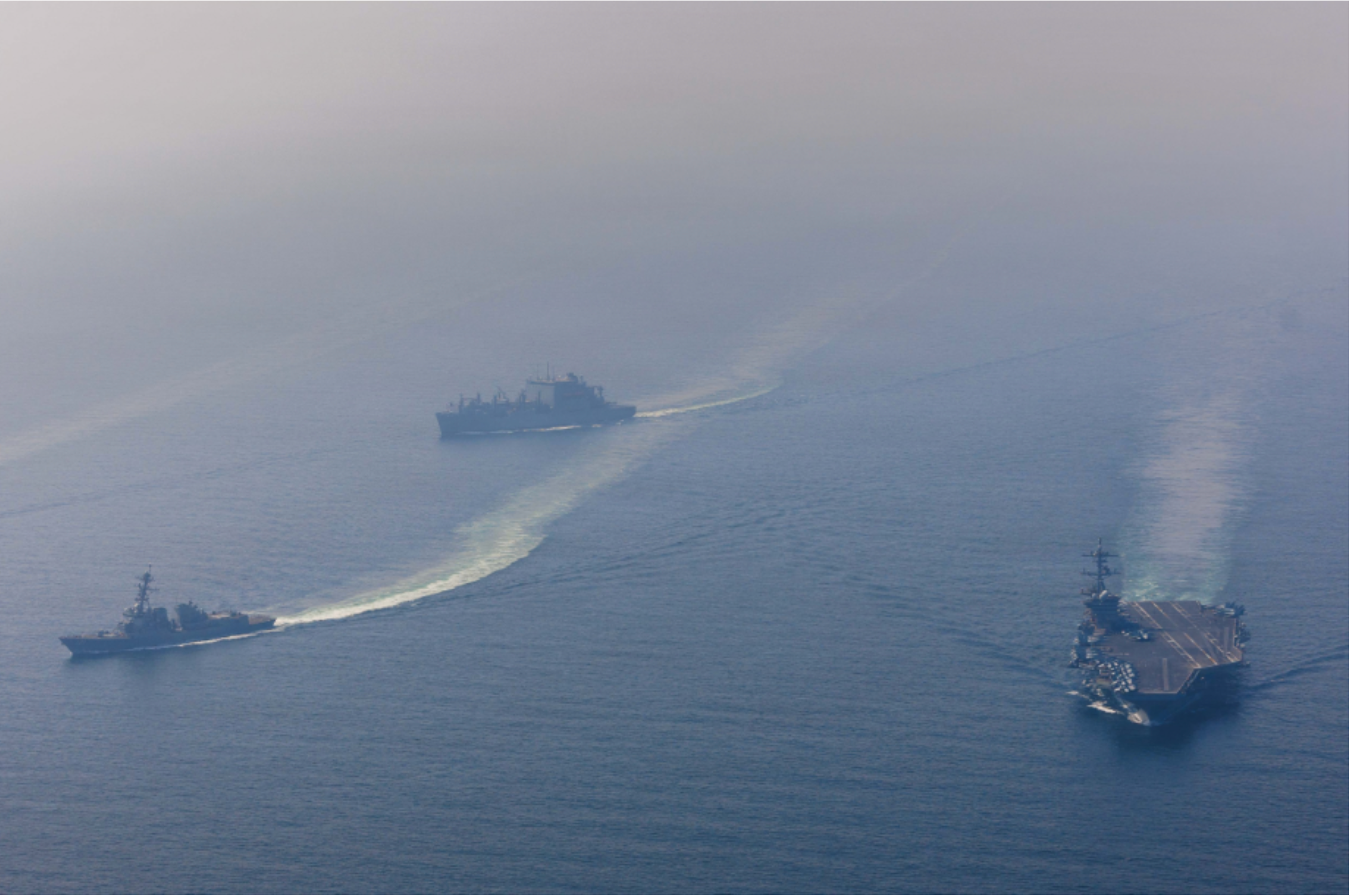 Naval vessels at sea representing military enforcement in the Strait of Hormuz.