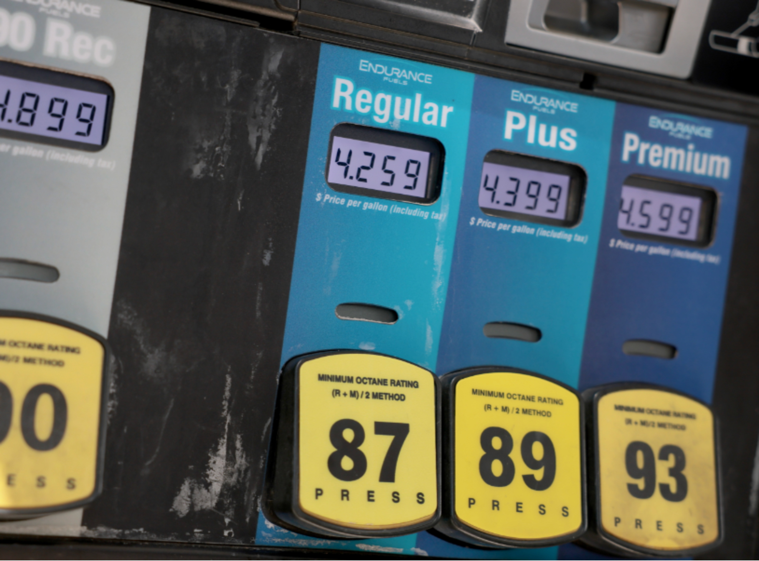 Gas pump price displays showing elevated gasoline prices across fuel grades.